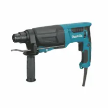 Blue Makita hammer drill shown in profile with black auxiliary handle and cord trailing below ready for masonry drilling